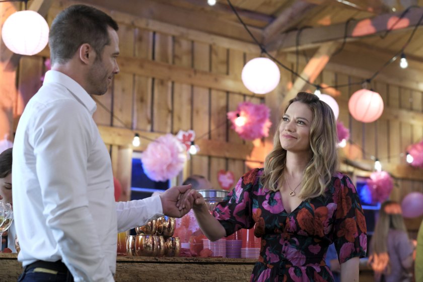 In a still from "A Valentine's Match", Natalie and her ex hold hands at the Valentine's Day festival. 