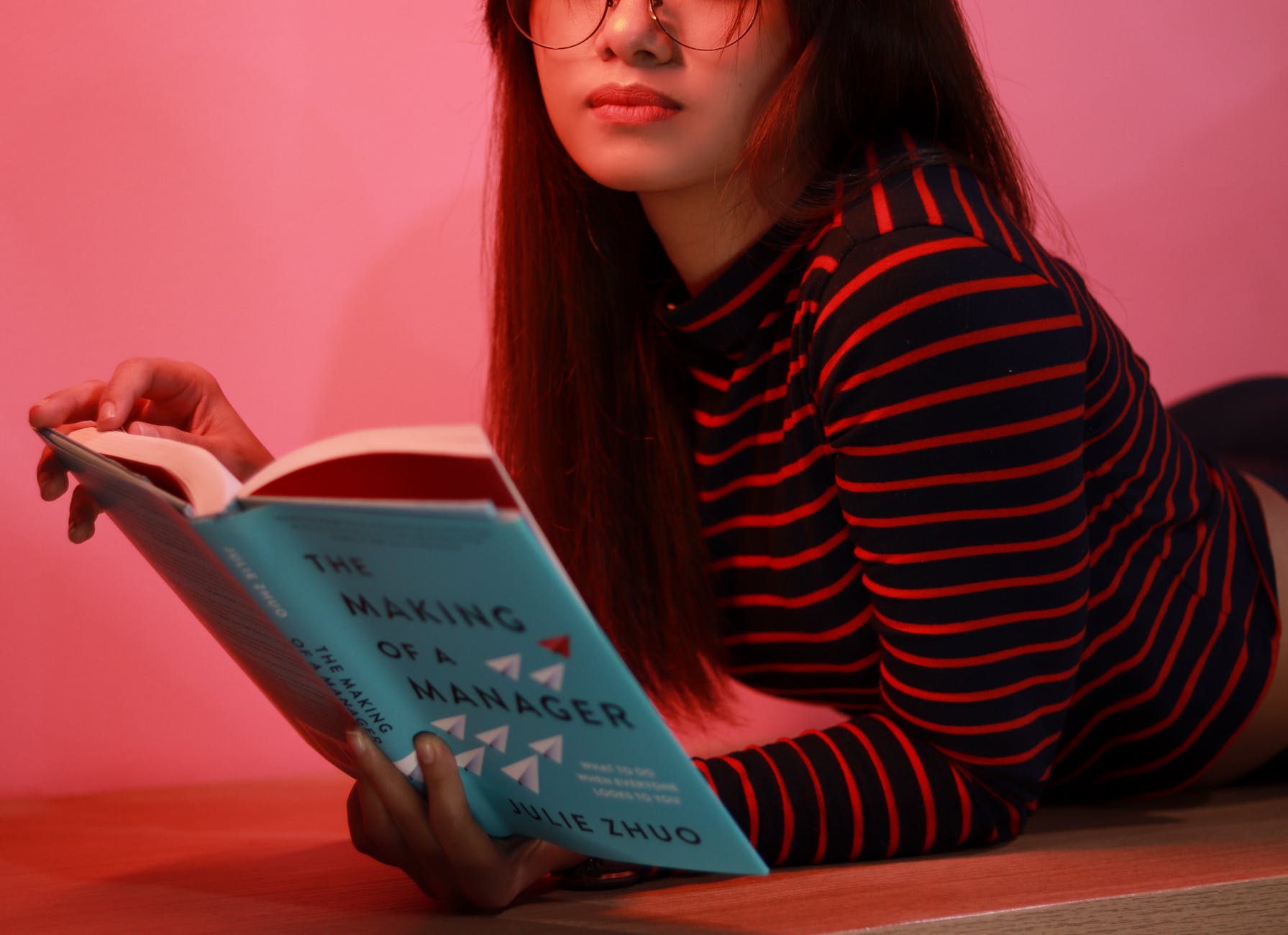 Young woman reads a book to further her career. 